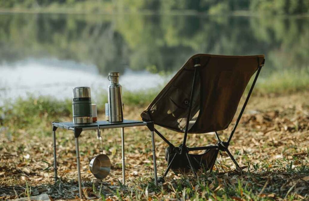 A camping chair that needs to be cleaned next to the water