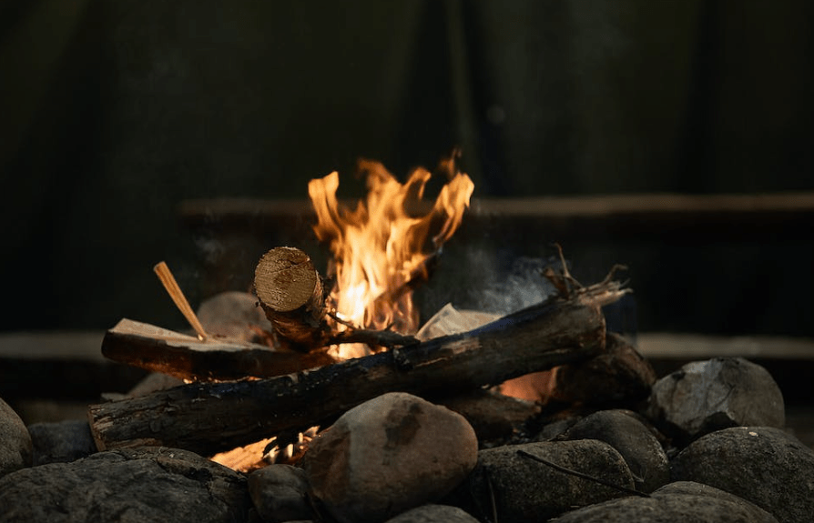 Campfire wood set on fire