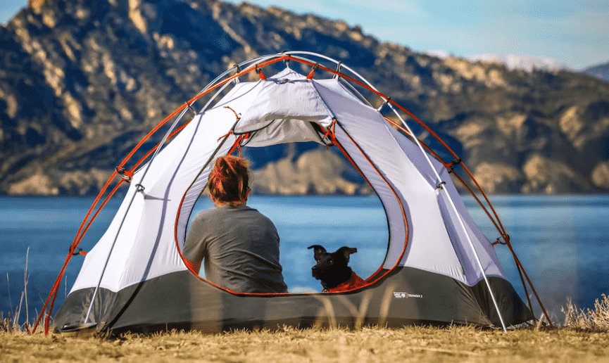 Girl relaxing on a camping trip in a good tent brand